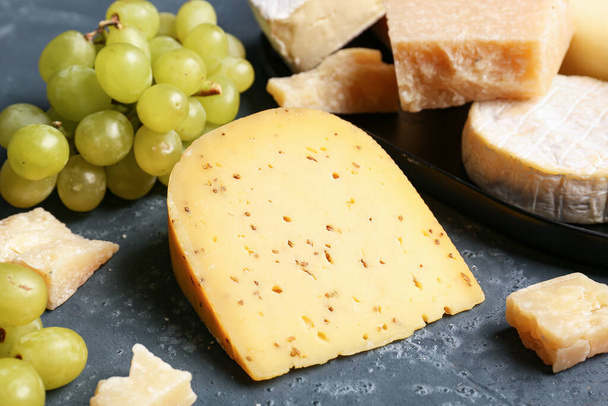 Piece of tasty cheese on blue background - Photo, Image