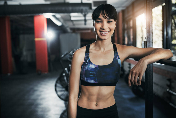 Im stronger, leaner and happier. a beautiful young woman out for a workout at the gym - 写真・画像