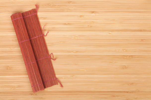 Japanese cooking mat over bamboo table - Photo, Image