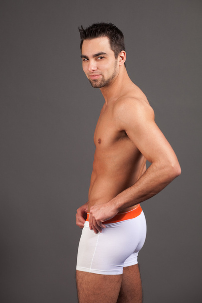 Attractive man in underwear. Studio shot over grey. - Фото, зображення