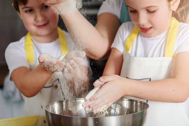 brother and sister working with dough - Photo, image