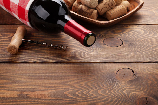 Red wine bottle, corks and corkscrew - Photo, Image