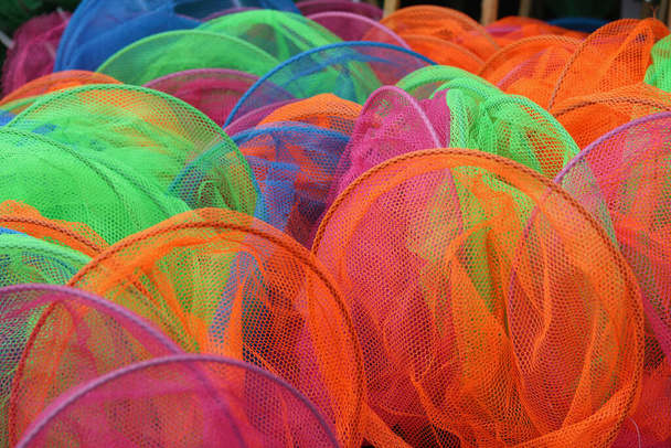 Full frame image of assorted nylon childrens fishing nets in bright colours. High quality photo - Fotografie, Obrázek
