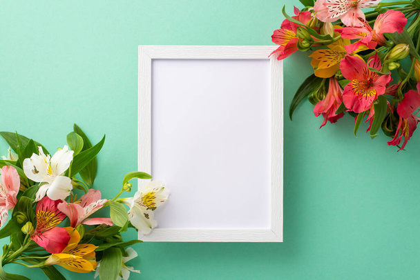 Summer time concept. Top view flat lay of alstroemeria flowers on pastel teal background with an empty frame for text or advert - Fotografie, Obrázek