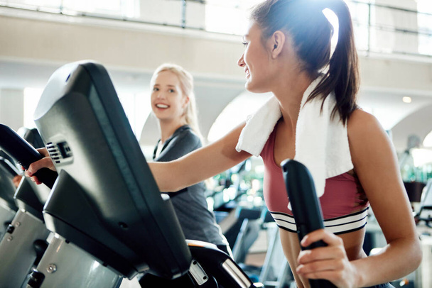 Time to step it up. attractive young women working out on treadmills at the gym - Photo, Image