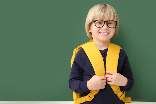 Happy little school child with backpack near chalkboard. Space for text - Zdjęcie, obraz