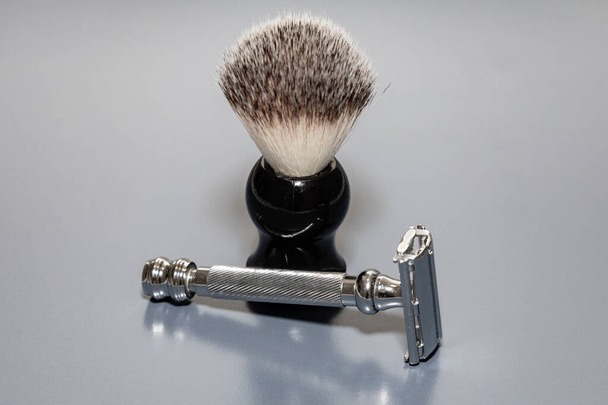 Vintage razor with shaving brush, isolated on plain background - Fotó, kép