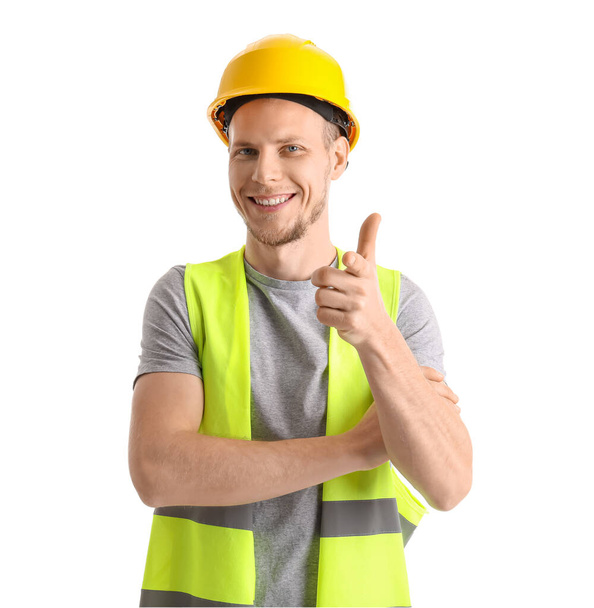 Male worker in vest and hardhat on white background - Fotó, kép