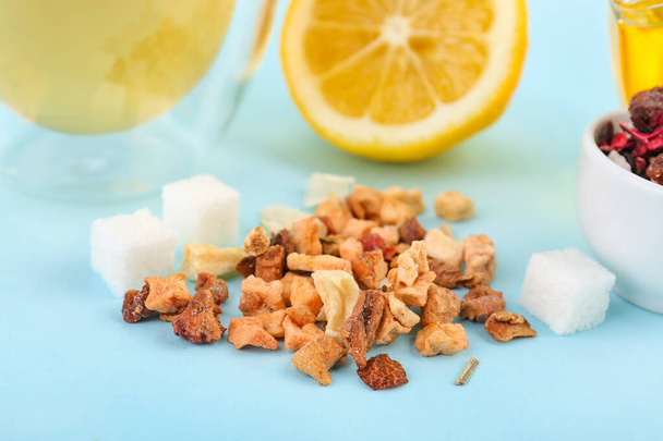 Heap of dried fruit tea and sugar on blue background, closeup - Photo, Image