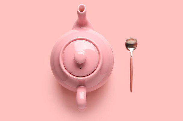 Cute ceramic teapot on pink background - Фото, изображение