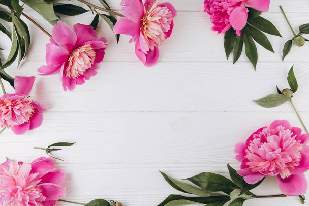Pink and white peonies on a white wooden background, copy space, flat lay, greeting card. - Zdjęcie, obraz