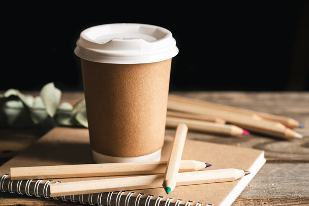 Paper Cup of coffee, wooden colored Pencils made from natural materials and recycled Notebook. - Zdjęcie, obraz