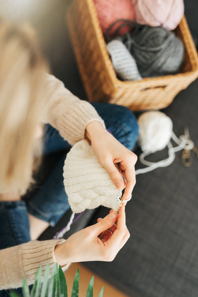 Young woman knitting warm scarf at home - Photo, image