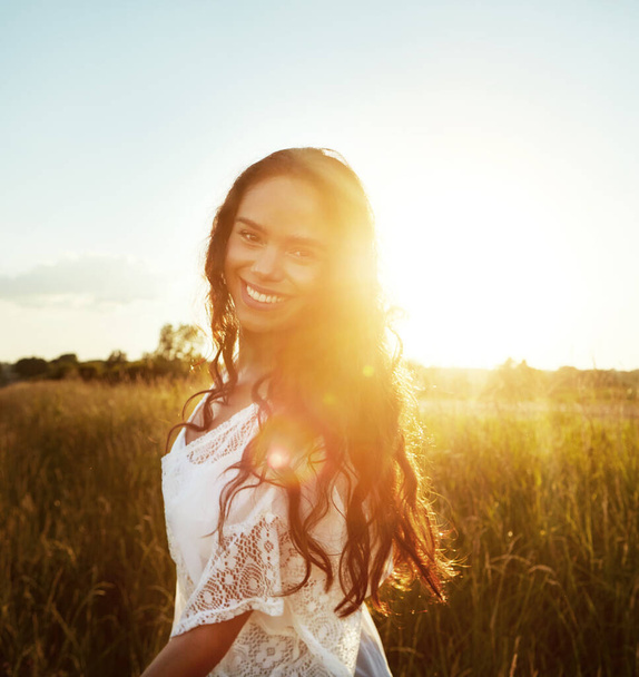 Breathtaking beauty. Portrait of an attractive young woman standing outside in a field - 写真・画像