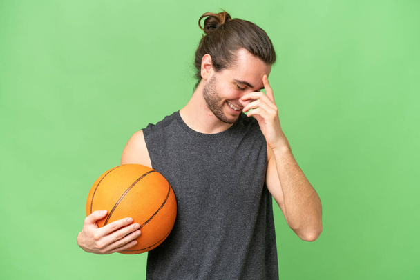 Young basketball player man over isolated background laughing - Fotó, kép