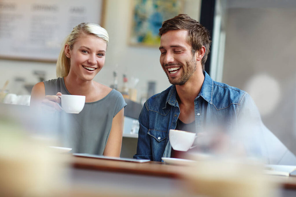 Having a good time on their coffee date. a young couple enjoying a date at a coffee shop - Foto, Imagem