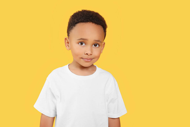 Portrait of cute African-American boy on yellow background. Space for text - Φωτογραφία, εικόνα