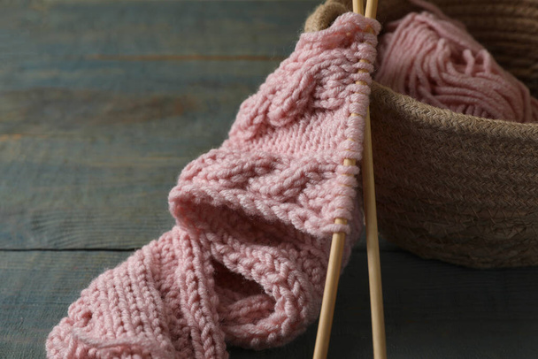 Soft pink woolen yarn, knitting and needles on wooden table, closeup. Space for text - Φωτογραφία, εικόνα