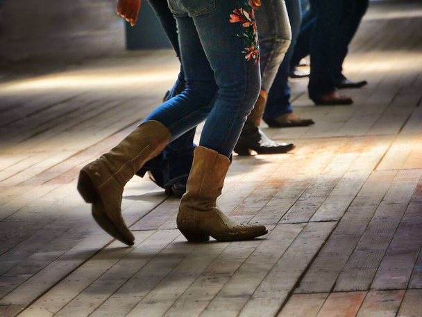 A closeup shot of the legs of traditional western folk dancing under the music - Foto, Imagen