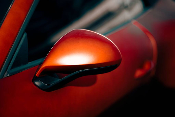 The side view mirror of a red Porsche 911 Carrera 4 GTS - Foto, Imagen