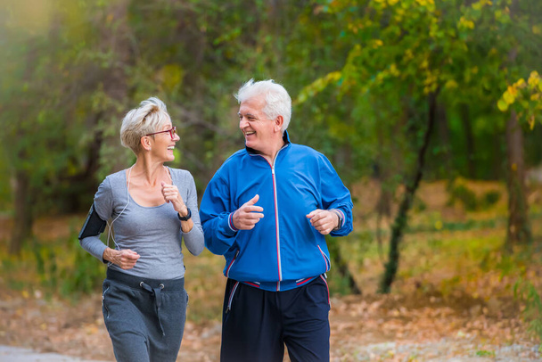 senior couple running in the park - Photo, Image