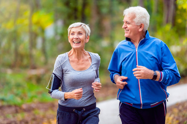 senior couple running in the park - Photo, Image