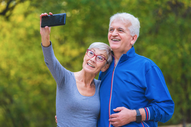 senior couple on the nature making selfie - Foto, Imagen