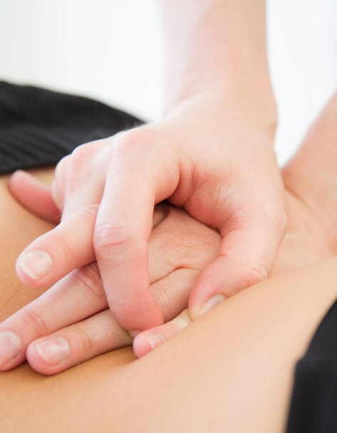 The Caucasian hands doing massage of a spine for pain relief, physical therapy - Photo, Image