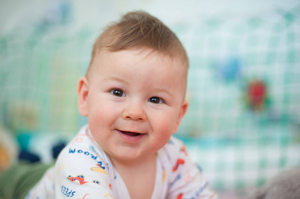 Portrait of cute happy baby boy looking at camera. Joy and happiness concept. Love and family emotion - Foto, Bild