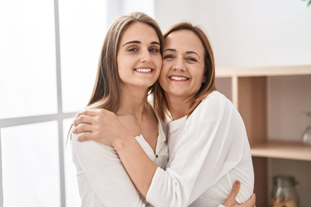 Two women mother and daughter hugging each other at home - Foto, Bild