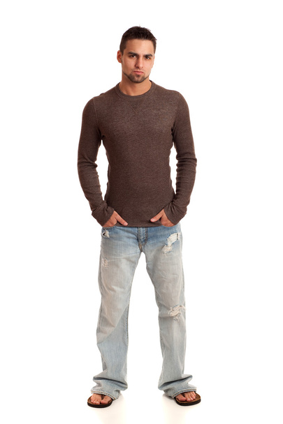 Young man in sweater and jeans. Studio shot over white. - Valokuva, kuva