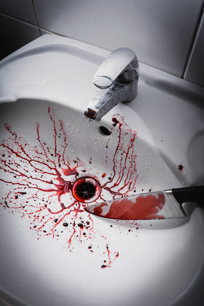 Closeup of dirty bathroom sink with blood splatter and knife - Foto, Imagem