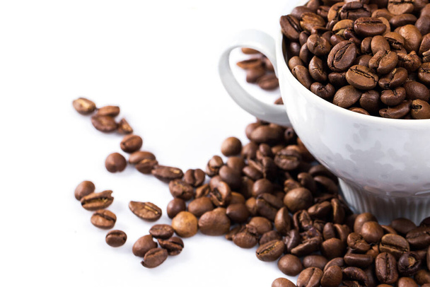 Coffee cup filled with a roasted coffee beans on white background - Foto, Imagen