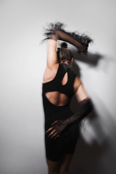 Fashion portrait of dancing woman wearing long tulle gloves taken with a long exposure for motion blur effect - Foto, Bild
