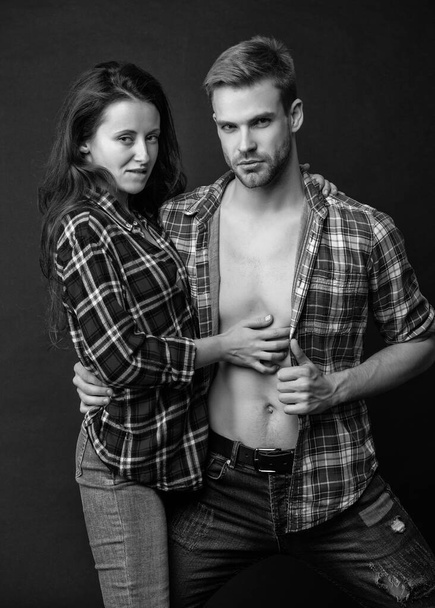 guy and girl together. desire. concept of romantic relationship. fashion and beauty. sexy couple in love on black background. young people. man and woman embracing. - Фото, зображення
