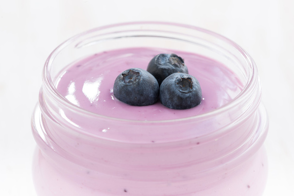Blueberry yogurt in a glass jar, close-up - Foto, Bild