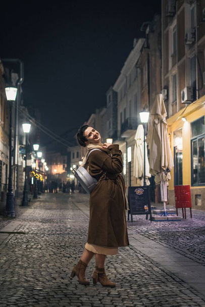 A Caucasian girl from Romania in an illuminated street - Foto, afbeelding