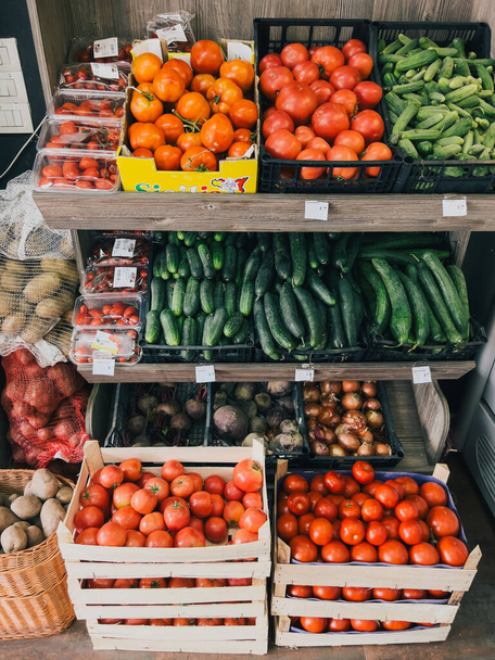 Boxes with fresh vegetables are on the shelves in the store. High quality photo - Fotoğraf, Görsel