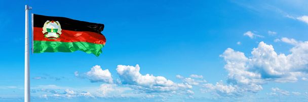 Afghanistan Flag (1980-1987), flag waving on a blue sky in beautiful clouds - Horizontal banner - Foto, imagen