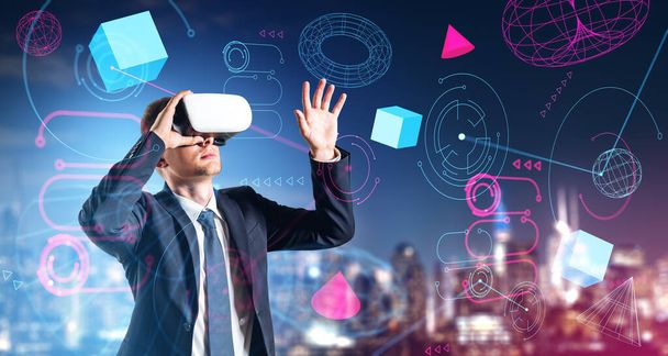 Portrait of young businessman in VR glasses using metaverse interface in blurry city. Concept of cyberspace and hi tech - 写真・画像