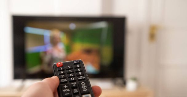 hand with remote control for tv set - Photo, image