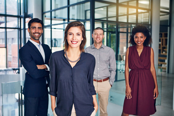 If youre looking for the best, theyre right behind me. Portrait of a team of confident professionals standing together in a modern office - Fotoğraf, Görsel