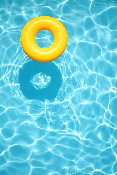 Yellow pool floats in a swimming pool - Photo, Image