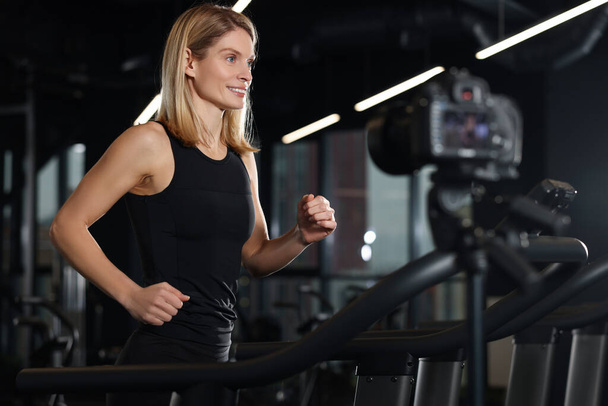 Fitness trainer recording online classes in gym - 写真・画像