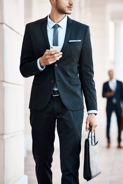 To the office I go. an unrecognizable businessman using a cellphone outside - Фото, изображение
