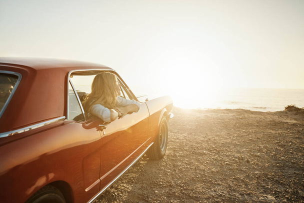 Lets escape to somewhere magical. a young woman enjoying a road trip along the coast - Zdjęcie, obraz