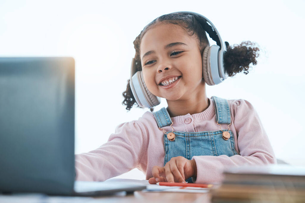 Computer, headphones and child listening in virtual class for e learning, language translation or knowledge at home. Happy kid on audio technology, laptop and online education for English development. - Zdjęcie, obraz