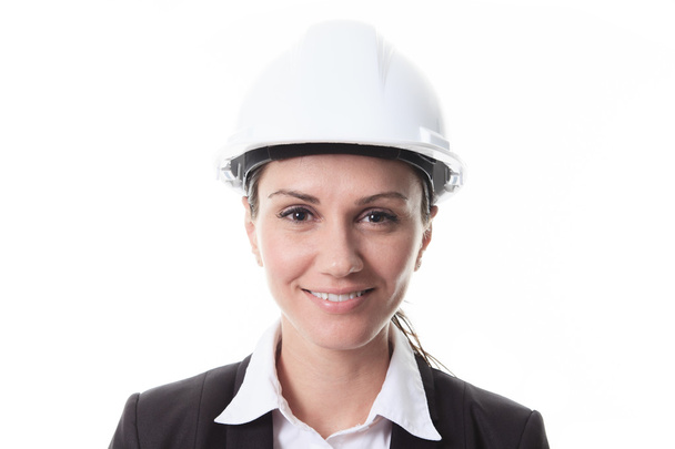 Attractive architect wearing helmet. All on white background. - 写真・画像