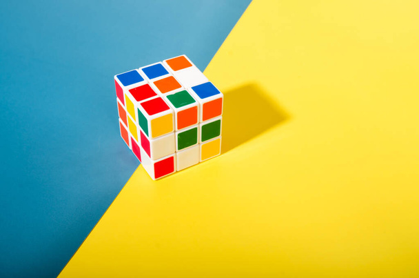 Thailand,Bangkok - April 11, 2023 Rubik's cube on a white background. Rubik's Cube on colored paper background Rubik's Cube invented by Hungarian architect Erno Rubik in 1974. - 写真・画像