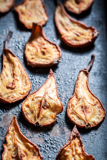 Delicious and healthy sun dried pears made of fresh fruits. Dried fruits in the sun in the garden. - Φωτογραφία, εικόνα